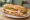 Bocadillo Especial: an illustration of pork, egg, cheese, tomato and more on baguette.