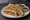 Bombay Toast Sandwich: an illustration of butter, potato, cucumber, tomato and more on white bread.