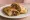 Boti Kebab Roll: an illustration of mutton, onion and yogurt on naan.