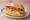 Bratwurst mit Kartoffelsalat Brötchen: an illustration of pork, potato, onion, vinegar and more on kaiser roll.