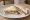 Brawn Sandwich: an illustration of pork, butter and mustard on white bread.