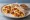 Breakfast Taco de Huevo con Chorizo: an illustration of egg, chorizo, cheese and salsa on tortilla.