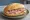 Broodje Achterham: an illustration of ham, butter and mustard on kaiser roll.