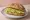 Broodje Avocado: an illustration of avocado, lemon and pepper on kaiser roll.