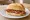 Broodje Bacon: an illustration of bacon and butter on kaiser roll.