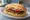 Broodje Beyond Meat: an illustration of lettuce, tomato and onion on kaiser roll.