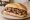 Broodje Biefstuk: an illustration of beef, butter and onion on kaiser roll.