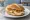 Broodje Brie: an illustration of brie, walnuts and honey on kaiser roll.