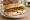 Broodje Caprese: an illustration of mozzarella, tomato, basil and olive oil on kaiser roll.