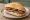 Broodje Cervelaat: an illustration of pork, sausage and butter on kaiser roll.