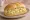 Broodje Eiersalade: an illustration of egg, mayonnaise, mustard and scallion on kaiser roll.