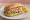 Broodje Garnalen: an illustration of shrimp, egg, mayonnaise and lettuce on kaiser roll.