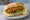 Broodje Garnalenkroket: an illustration of shrimp, lemon and lettuce on kaiser roll.