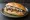 Broodje Gerookte Haring: an illustration of herring, onion and butter on kaiser roll.