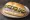 Broodje Haring met Augurk: an illustration of herring, pickle and onion on kaiser roll.