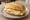 Broodje Kaas met Mosterd: an illustration of gouda, mustard and butter on kaiser roll.