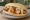 Broodje Kibbeling: an illustration of cod, garlic sauce and remoulade on kaiser roll.