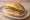 Broodje Leverworst: an illustration of pâté, butter and pickle on kaiser roll.