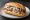 Broodje Makreel: an illustration of butter and onion on kaiser roll.