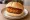 Broodje Nasischijf: an illustration of rice and sriracha on kaiser roll.