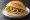 Broodje Pastei: an illustration of chicken and onion on kaiser roll.
