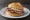 Broodje Rosbief: an illustration of beef, remoulade, mustard and butter on kaiser roll.
