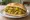 Broodje Roti: an illustration of chicken, potato, curry powder and onion on kaiser roll.