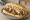 Broodje Shoarma: an illustration of chicken, lamb, garlic sauce, lettuce and more on kaiser roll.