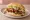 Broodje Shoarma met Sambal: an illustration of lamb, sriracha, lettuce, tomato and more on kaiser roll.