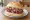 Broodje Tartaar: an illustration of beef, onion, caper, mayonnaise and more on kaiser roll.