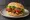 Broodje Tempeh: an illustration of lettuce, tomato and onion on kaiser roll.