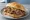 Broodje Warm Vlees: an illustration of beef, pork, gravy and mustard on kaiser roll.