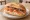 Broodje Zalm: an illustration of salmon, cream cheese, onion and dill on kaiser roll.