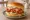 Buffalo Chicken Sandwich: an illustration of chicken, butter, lettuce, tomato and more on burger bun.