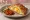 Burekas with Egg: an illustration of egg and pickle.