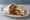 Burrito: an illustration of beef, beans, rice, cheese and more on tortilla.