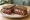 Cannibal Sandwich: an illustration of beef, onion and pepper on rye bread.