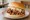 Carolina Pulled Pork: an illustration of pork, vinegar, mustard and coleslaw on burger bun.