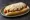 Carolina Slaw Dog: an illustration of pork, pepper, mustard, onion and more on hot dog bun.