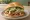 Cemita de Carnitas: an illustration of pork, avocado and onion.