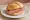 Cervelatwurst Brötchen: an illustration of butter and mustard on kaiser roll.