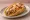Chalupa: an illustration of pork, lettuce, tomato, cheese and more on tortilla.