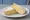 Cheddar Sandwich: an illustration of cheddar cheese and butter on white bread.