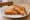 Cheese and Beans Toastie: an illustration of cheddar cheese, beans and butter on white bread.