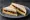 Cheese and Branston: an illustration of cheddar cheese, pickle and butter on white bread.