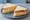 Cheese and Coleslaw: an illustration of cheddar cheese, coleslaw and butter on white bread.