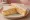 Cheese and Coleslaw: an illustration of cheddar cheese, coleslaw and butter on white bread.