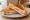 Cheese and Ham Toastie: an illustration of ham, cheddar cheese and butter on white bread.