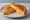 Cheese and Onion Toastie: an illustration of cheddar cheese, onion and butter on white bread.