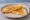 Cheese Quesadilla (USA): an illustration of cheddar cheese and monterey jack on tortilla.